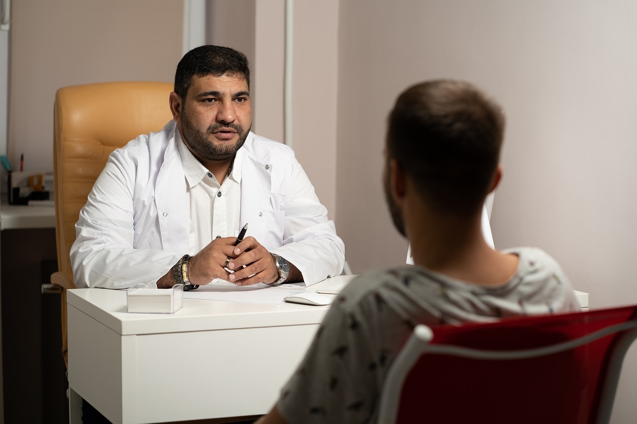 doctor sitting at desk is speaking with a patient about suboxone treatment options