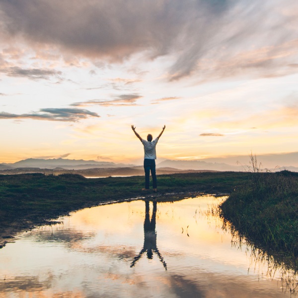 A Man Standing in Nature with Arms Raised, Symbolizing Lasting Recovery from Addiction in London, OH