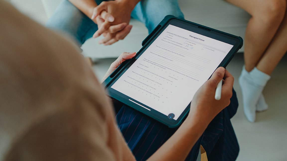 A Healthcare Provider Is Reviewing an Assessment Form During a Counseling Session in Columbus, OH